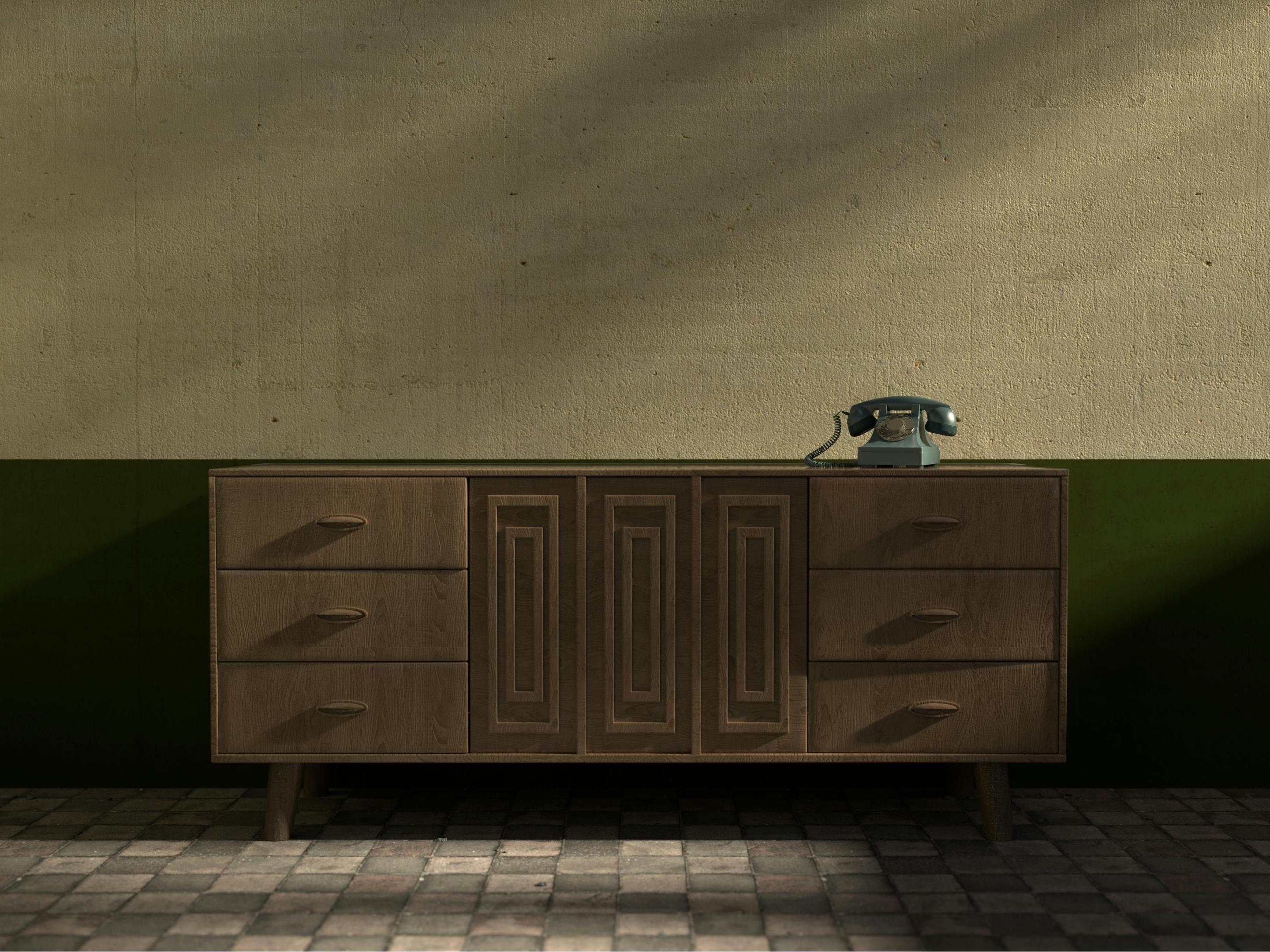 A vintage-style wooden sideboard with a classic rotary phone on top