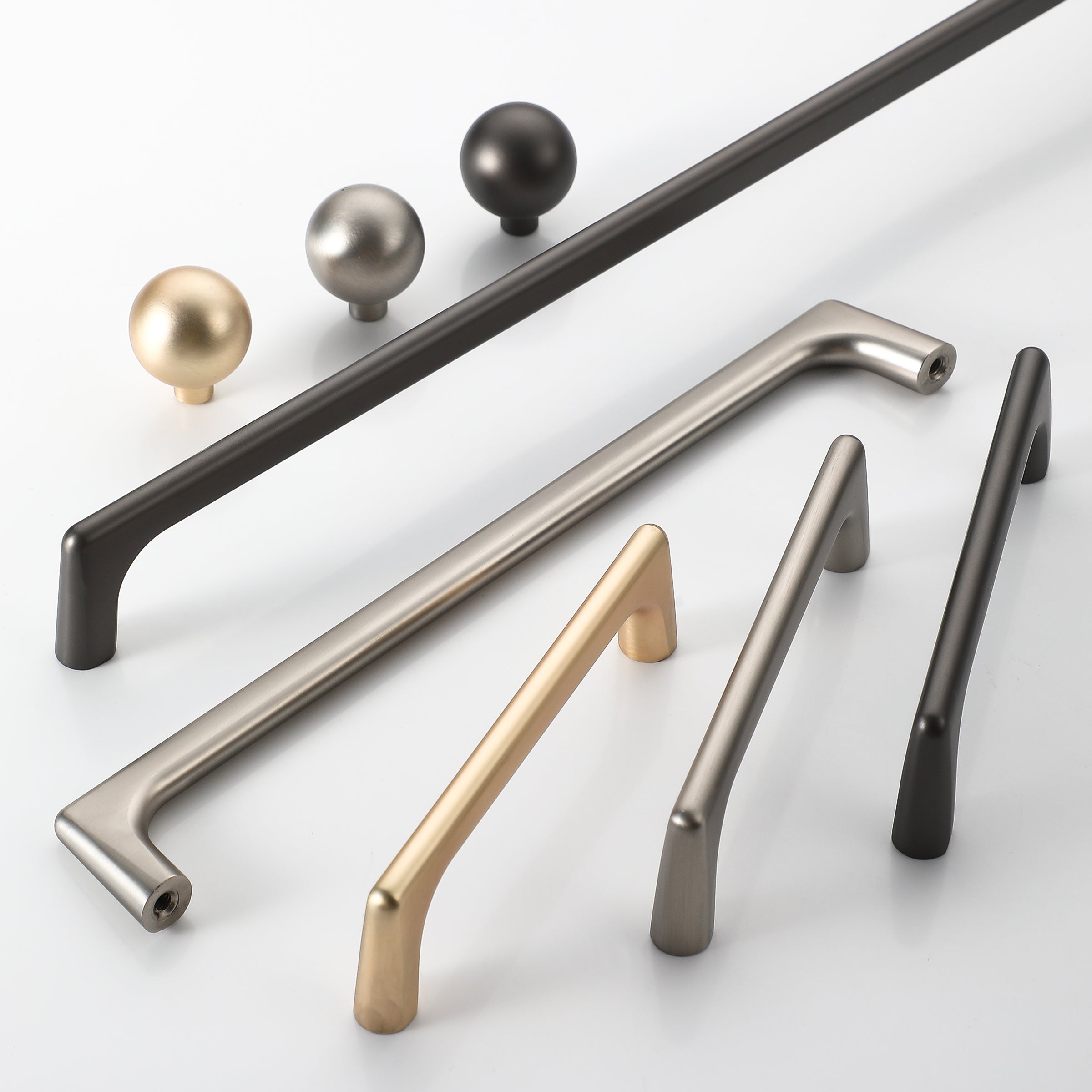 Collection of D-shape kitchen cabinet handles in brushed nickel, bronze, and gold finishes.