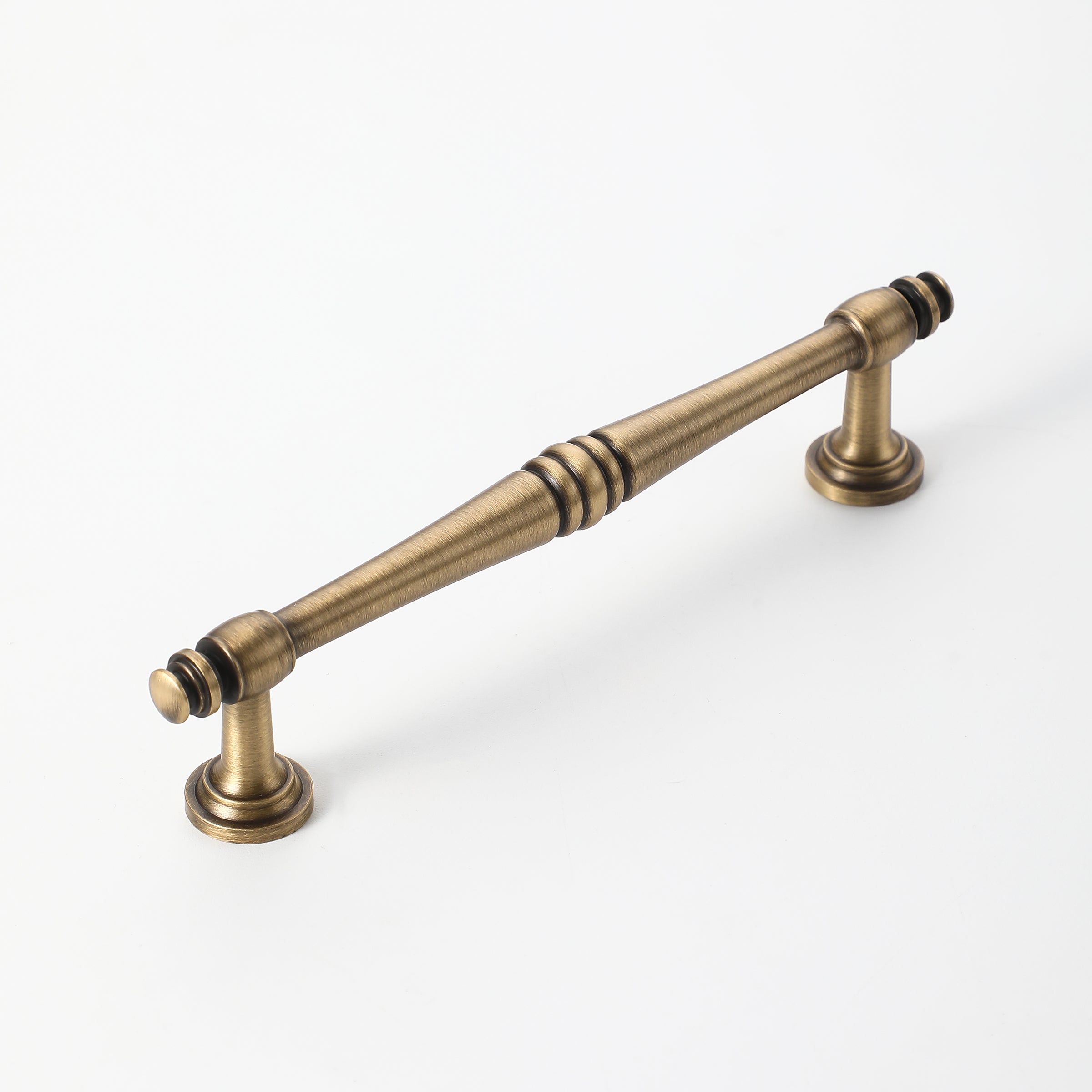Classic brass kitchen handle with ergonomic spindle shape.