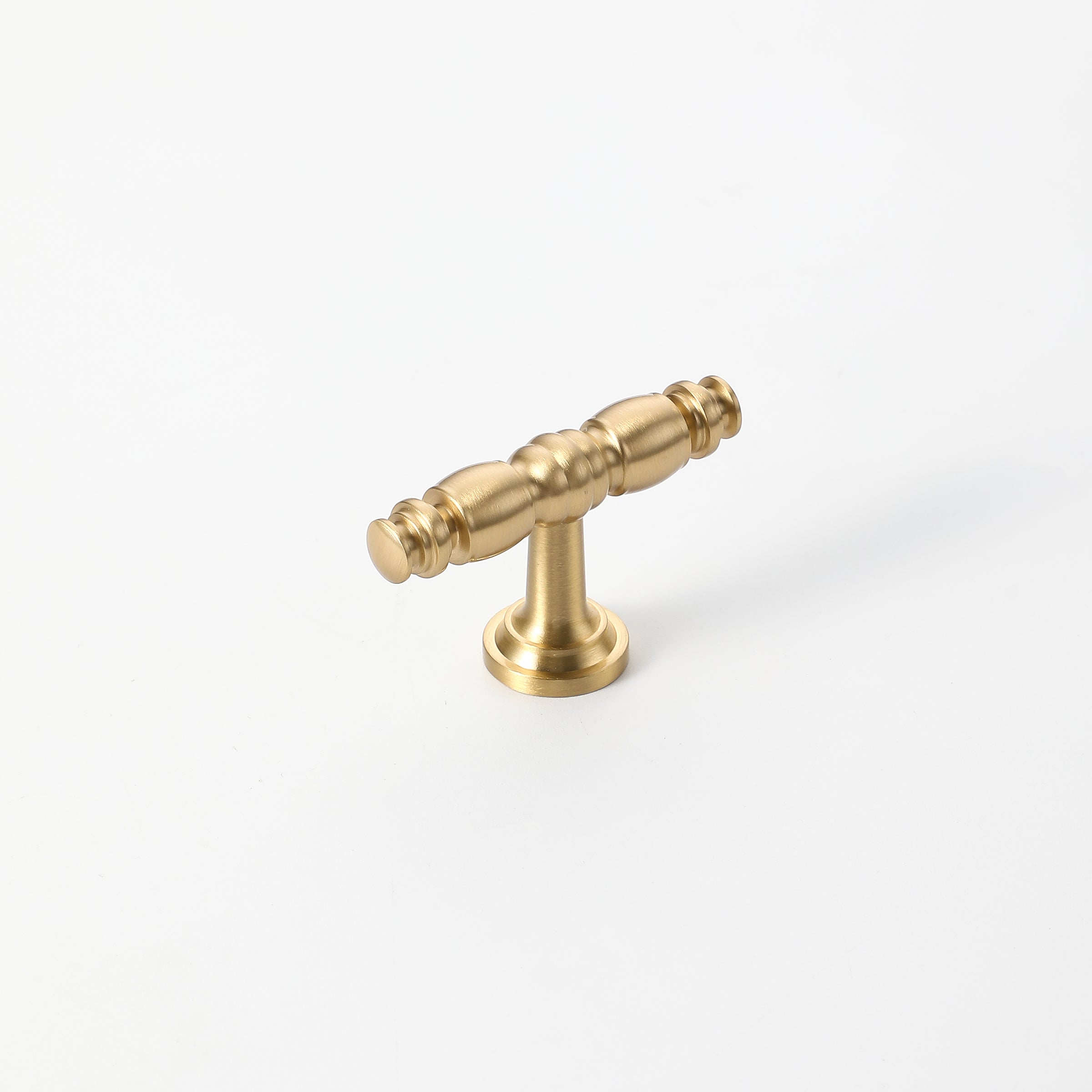 Brushed gold cabinet knob with classic spindle design for kitchen furniture.