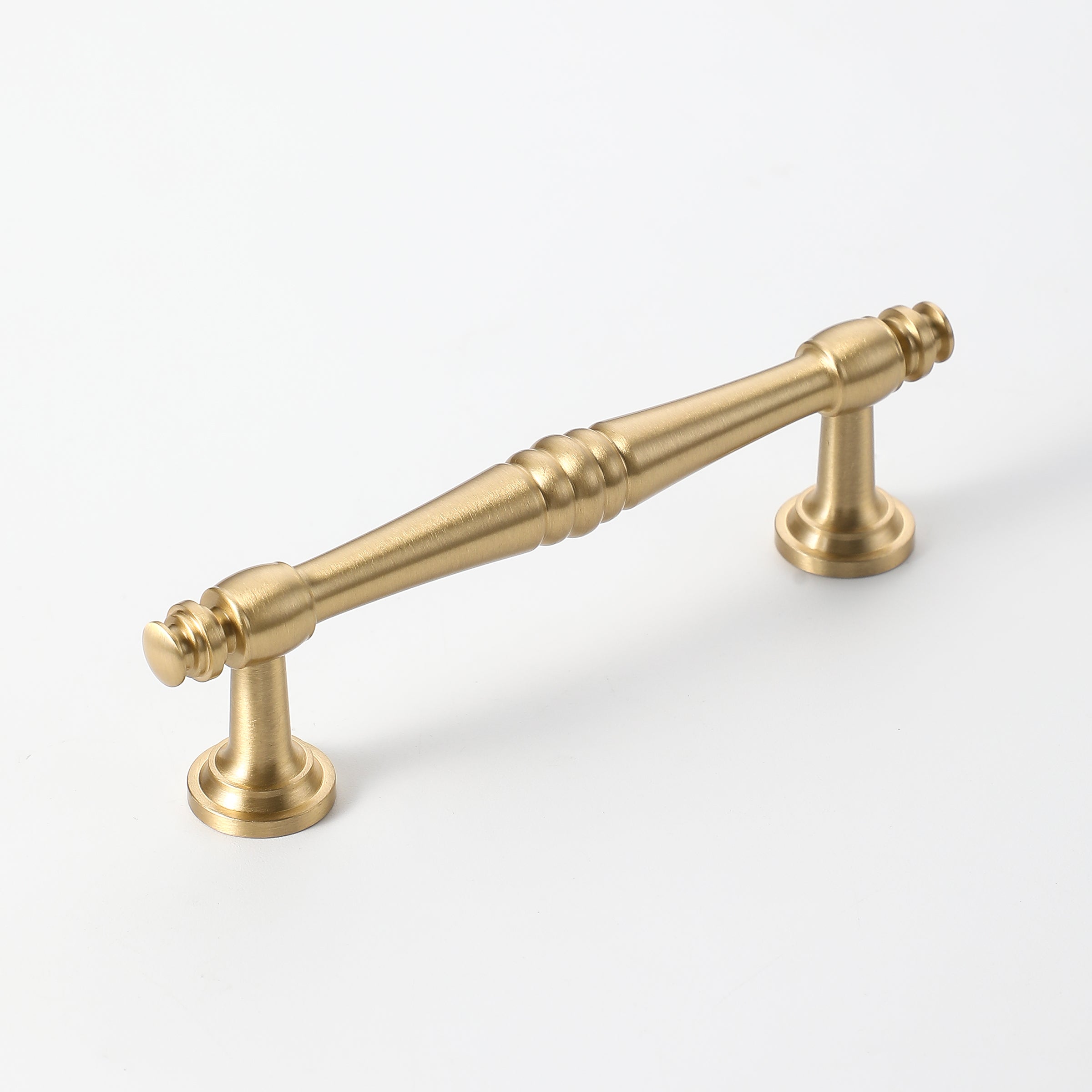 Brushed gold cabinet handle with elegant spindle detailing for drawers.