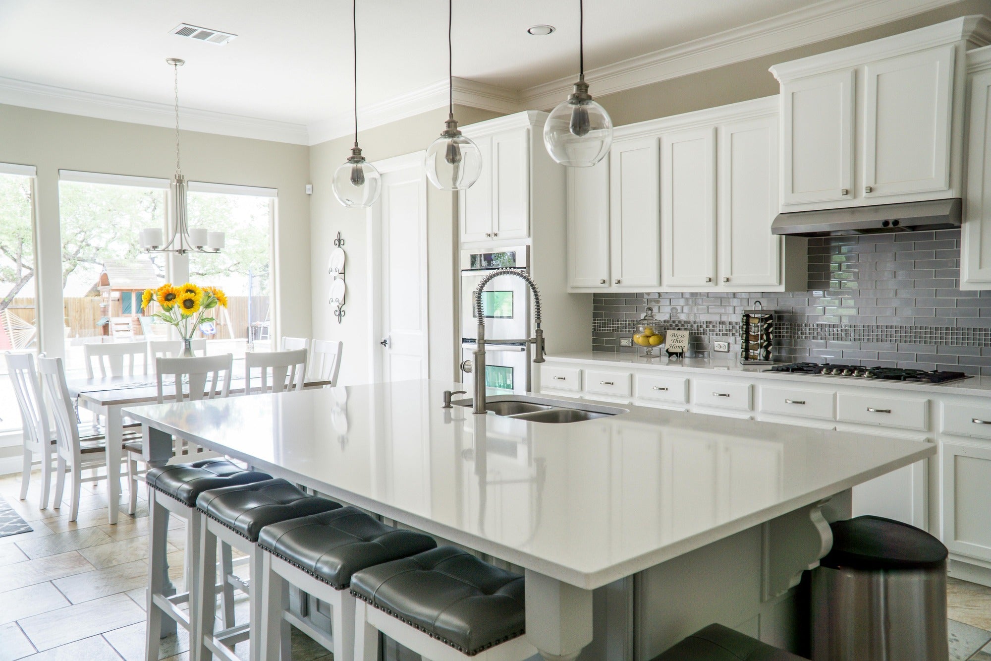 White kitchen cabinets with copper round knobs