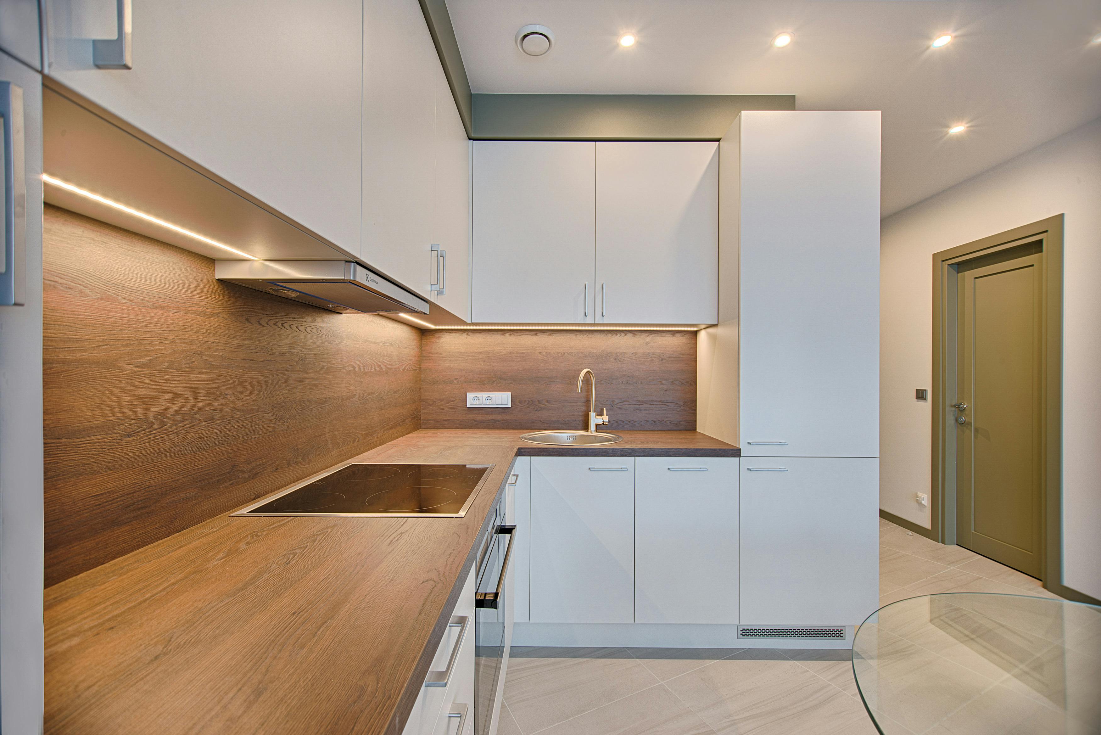 a modern kitchen with white cabinets