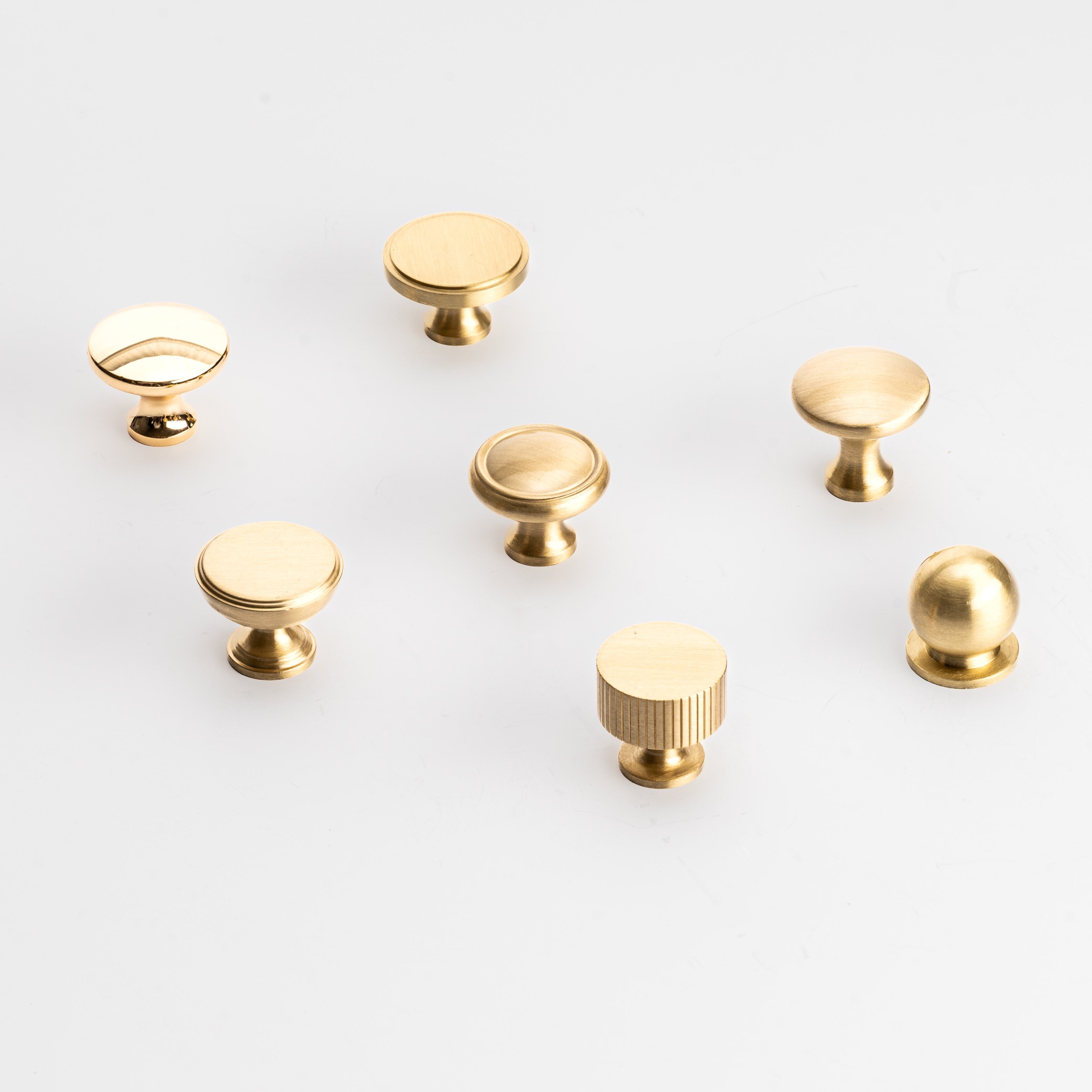 Various brass door knobs featuring round and textured designs